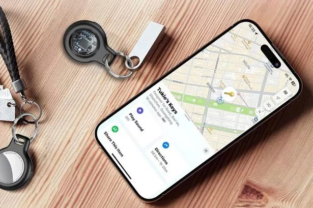 A collection of the best smart tracker AirTag alternatives for Android phones, including a Tile Mate, Samsung SmartTag, and Chipolo ONE, arranged next to a smartphone.